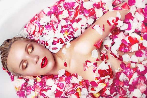 Portrait of a sensuall blonde woman in water with rose petal, sp