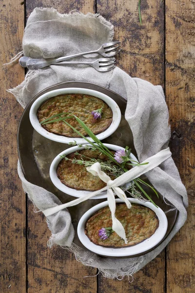 Rustic vegetables little souffles with flowers on vintage background