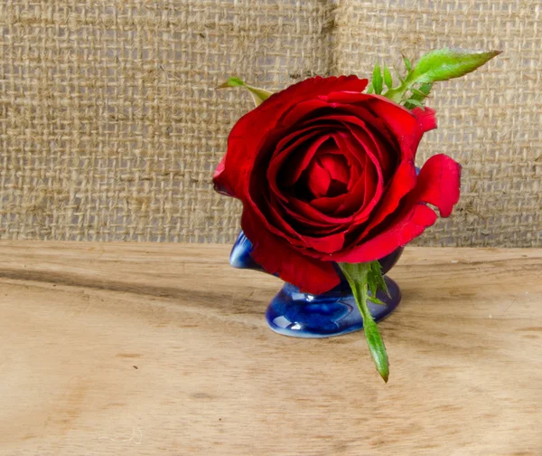 Element design of red rose and pearl on wooden floor and sack texture background