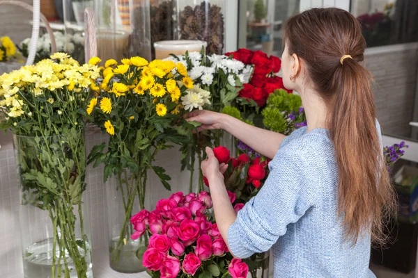 Woman caring for flowers at the shop