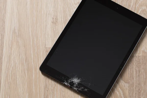 Black tablet computer with broken glass