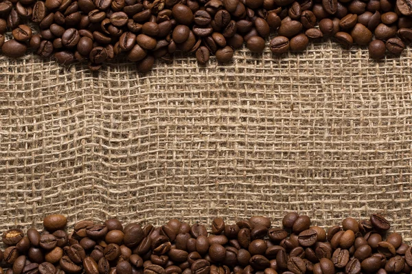 Roasted coffee beans stripes on burlap texture
