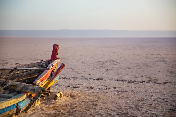 Abandoned colourful Boat in desert at dawn. Tunisia