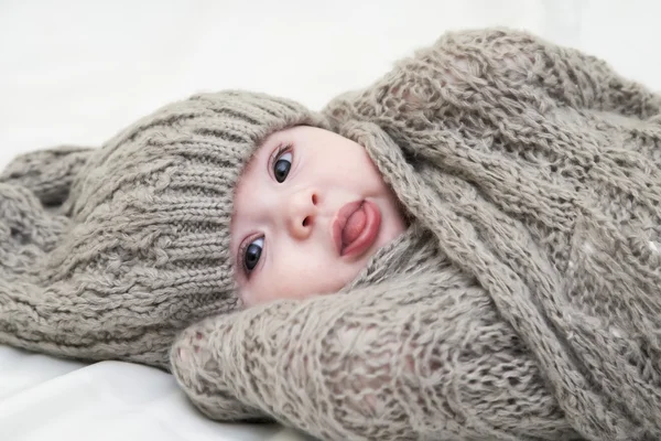 Cute little baby. Newborn baby girl in pink knitted hat.