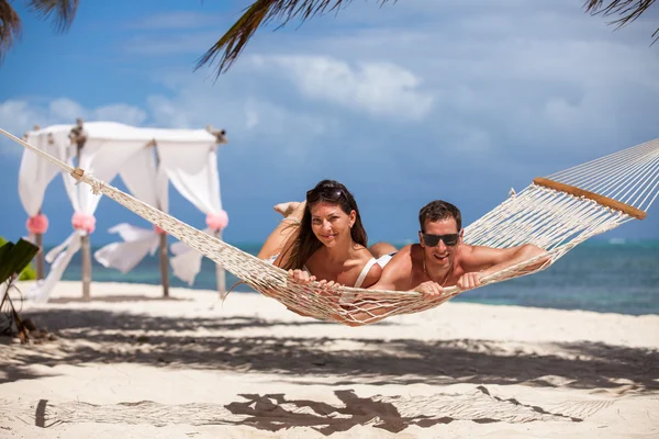 Romantic Couple Relaxing In Beach Hammock