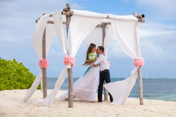 Young loving couple wedding in gazebo.