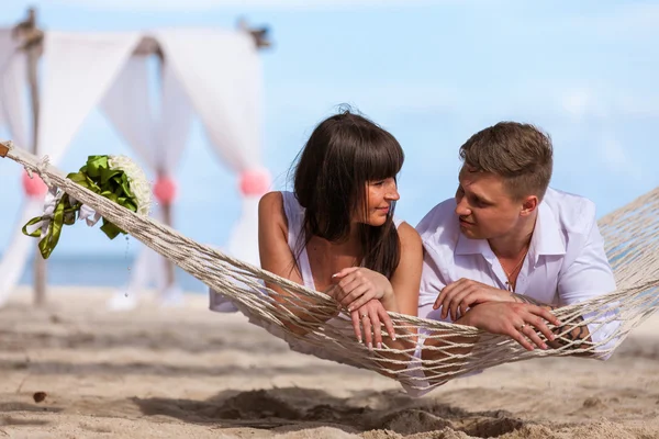 Romantic Couple Relaxing In Beach Hammock