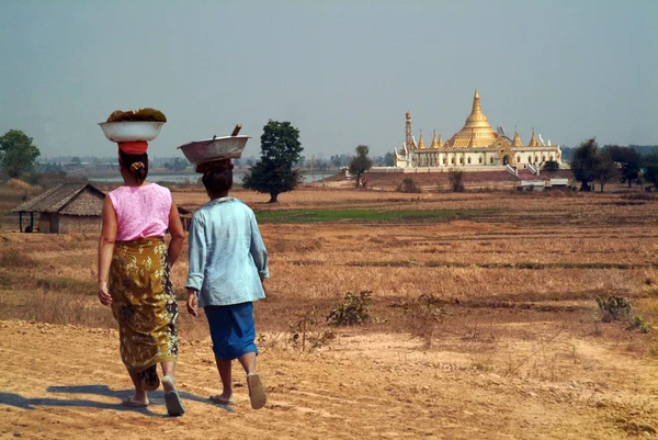 Burmese woman carrying on their heads.