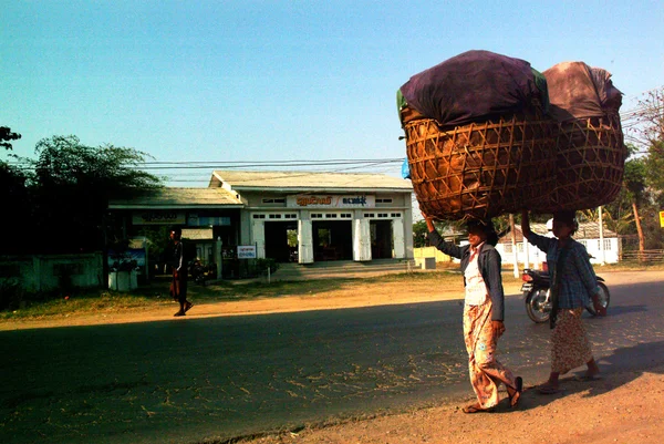 Burmese woman carrying on their heads.