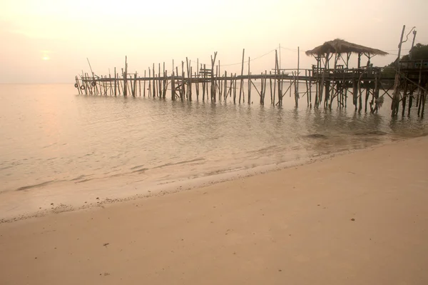 Silhouette of traditional wooden bridge on the beach.