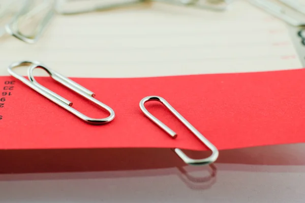Paper clip and red paper