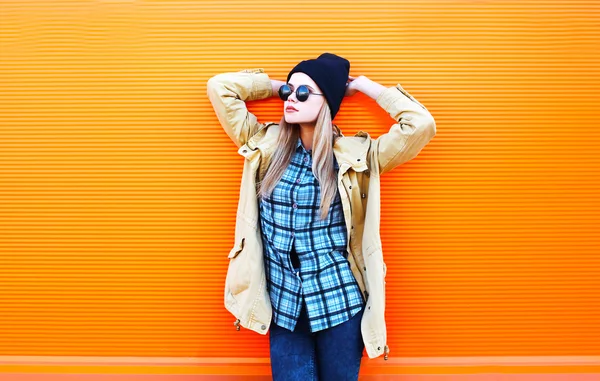 Fashion pretty woman model over colorful orange background