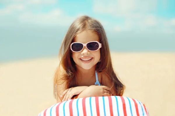 Joyful child resting on the beach in the summer, travel, recreat