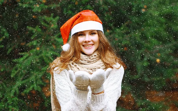 Christmas and people concept - happy young girl in winter hat ne
