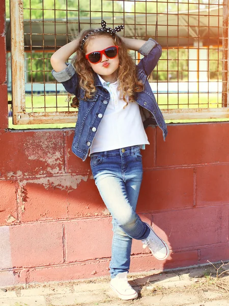 Fashion kid concept - stylish little girl child wearing a jeans