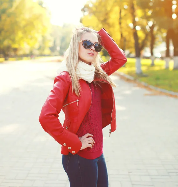 Fashion young woman wearing a red leather jacket with scarf in a
