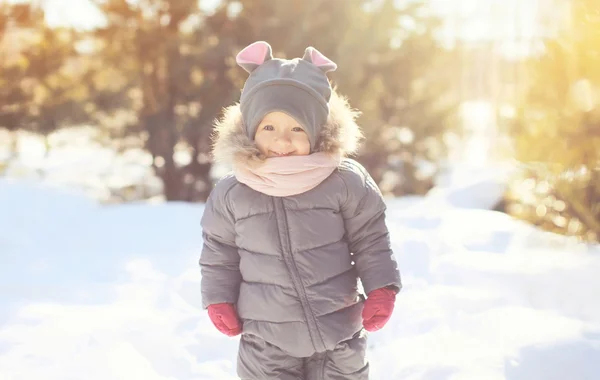 Cheerful smiling little child walking in winter day