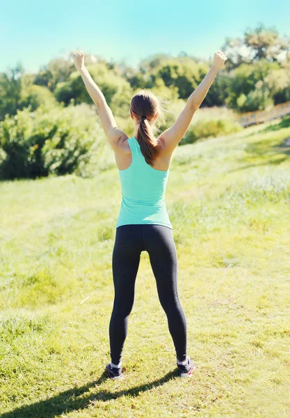 Fitness happy runner woman enjoying after training in park, runn