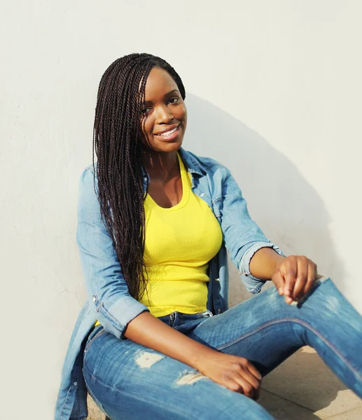 Beautiful smiling african woman wearing a jeans clothes