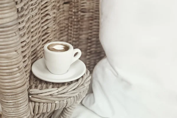 Wicker armchair, white pillow