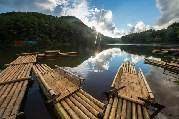 Wooden raft with the sun