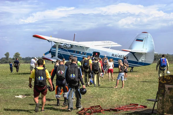 Skydivers make boarding the plane an-2 for the jump.