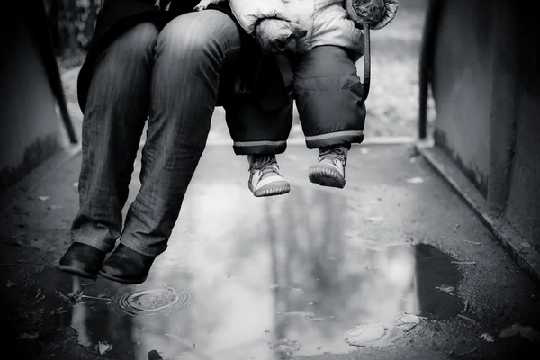 Adult and child swinging on a swing