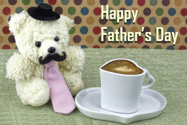 Generic teddy wearing a tie with cup of coffee. Fathers day theme