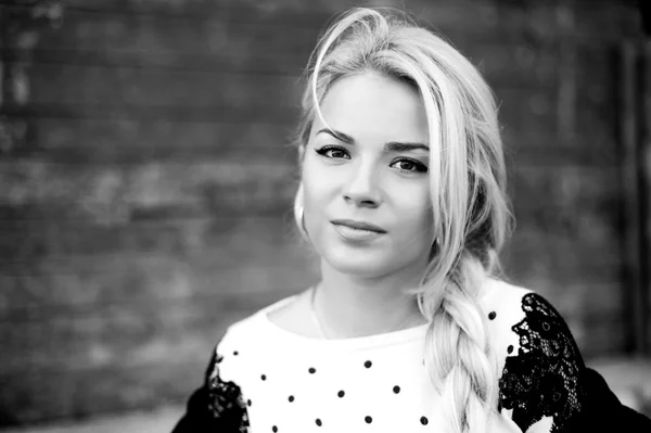 Black and White portrait of  beautiful woman with blond hair in a sweater outdoors