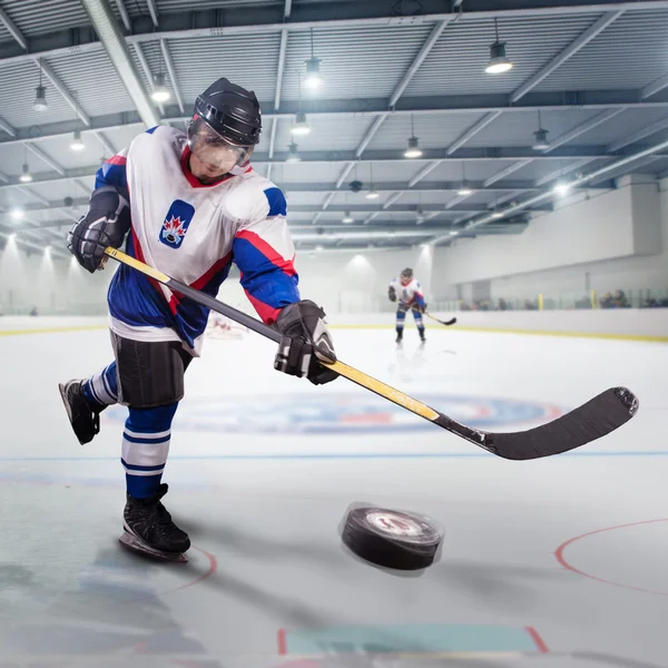 Hockey player shoots the puck and attacks