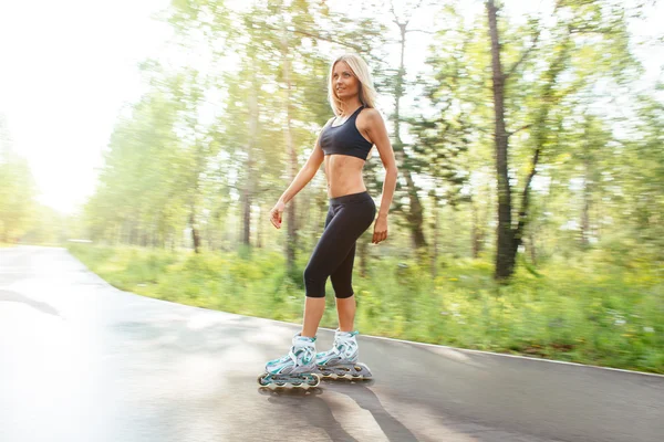 Roller skating sporty girl in otdoor. Caucasian woman in outdoor fitness activities