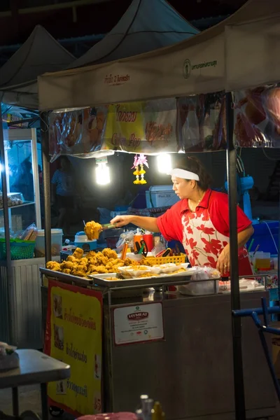 Woman selling fried chicken at the night market