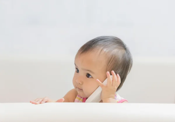 Baby play role talking to a cell phone