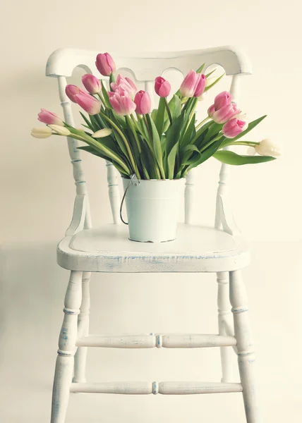 Bright tulips on chair