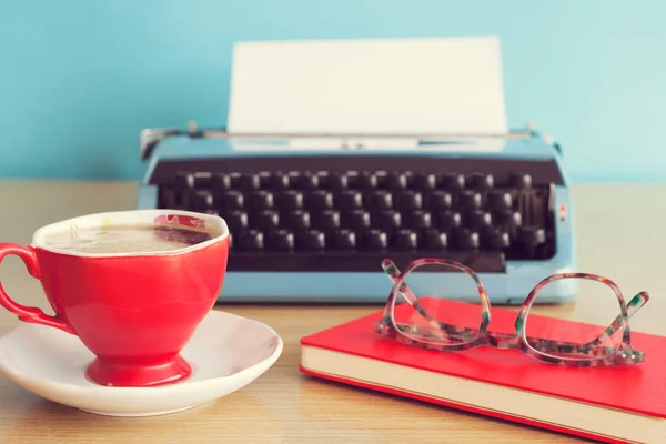 typewriter, coffee cup and eyeglasses