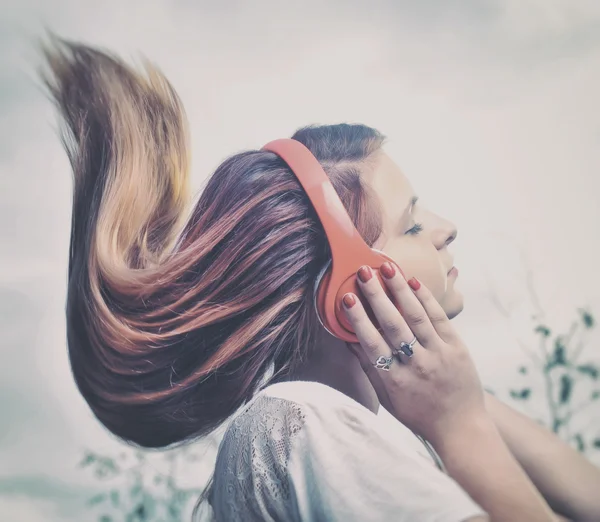 Girl listening to music on headphones