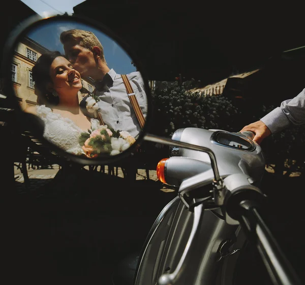 Bride and groom in the mirror reflection