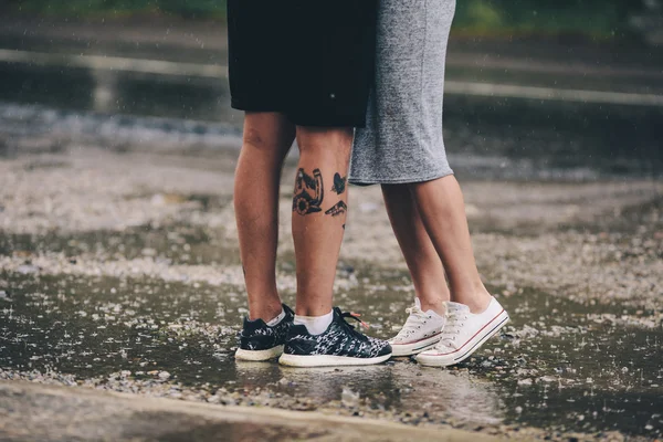 Couple on the background of wet asphalt