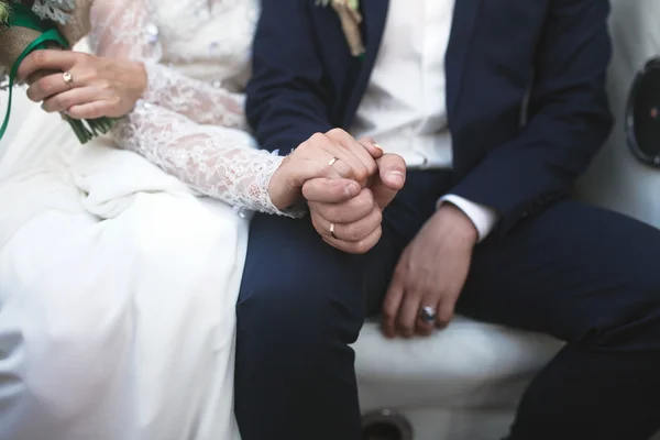 Bride and groom holding hands