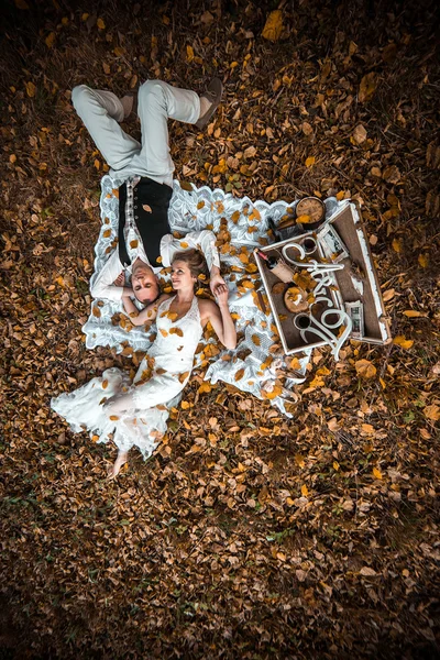 Wedding couple lying under a tree