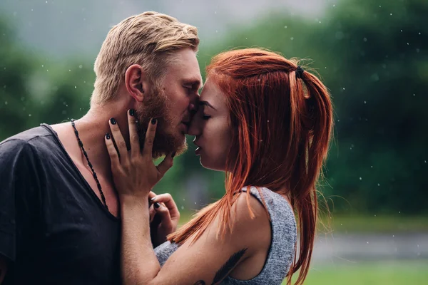 Beautiful couple kissing in the rain