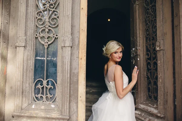 Bride standing in front of the old door