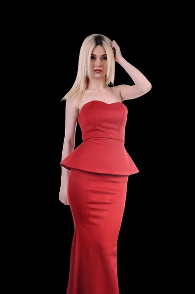 Beautiful fashion model stay in elegant pose, A sexy model in red dress is posing elastically, a cute model staying and looking down lovely