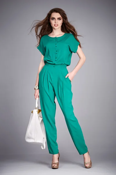 Beauty sexy woman wear stylish casual clothing for meeting walk silk blouse cotton pants high heels shoes perfect body shape fashion catalog in studio accessory long brunette hair natural make up bag