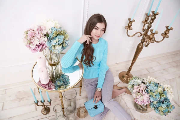 Beauty woman in perfect home interior comfort furniture flower candle girl wear casual fashion wool sweater style pants and shoes clothes for office walk date natural makeup and sexy body