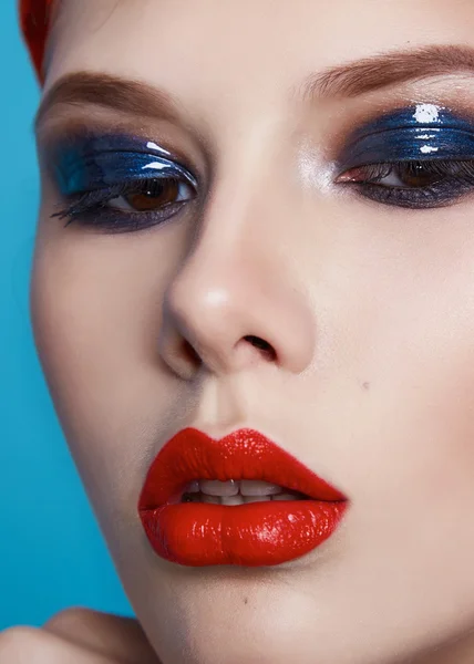 Beautiful sexy woman color makeup red lips blue eyes cosmetics