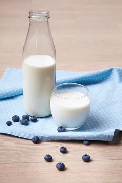 One bottle fresh cow milk and glass breakfast healthy morning diet vitamin organic natural food and drink berries blueberries