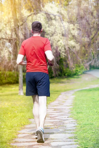 Man jogging outdoors in a park