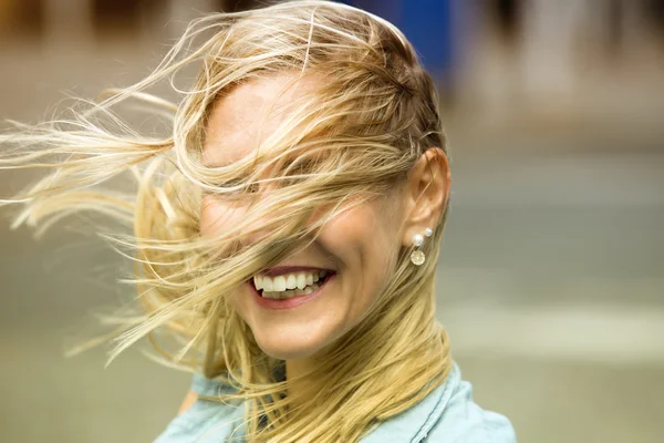 Portrait of laughing happy blond woman