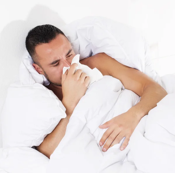 Man in bed with a cold